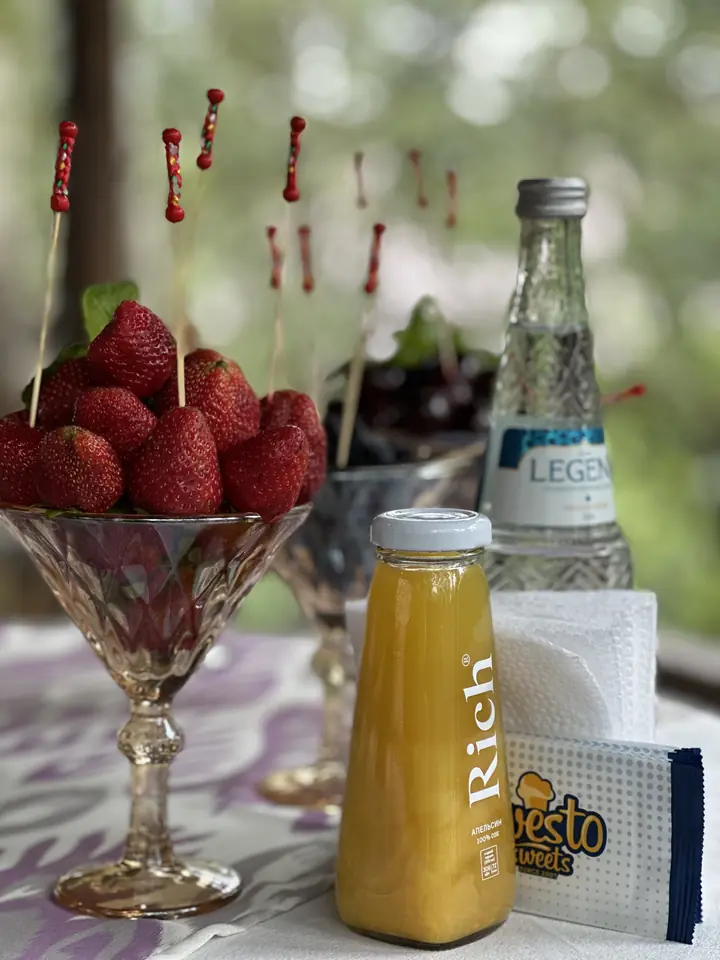 Juice, water and strawberry skewers on a buffet table